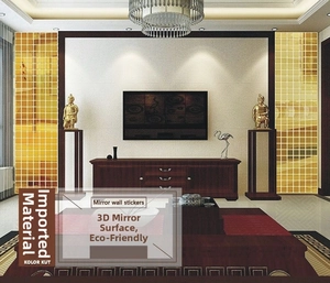 Detail of golden acrylic self-adhesive square mirror wall stickers on a living room wall