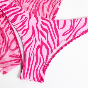 Detail of pink zebra print high-cut bikini bottoms and matching mesh cover-up set
