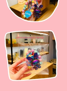 Close-up of a gradient beaded keychain with a metallic rabbit charm and Love heart tag