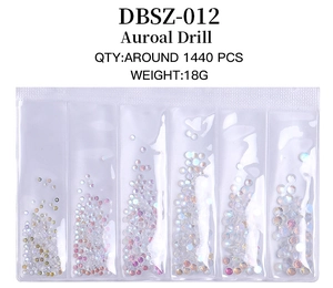Macro view of iridescent aurora nail art crystals in 6-grid plastic case for manicure