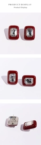 Detail view of wine red enamel rectangular studs with large emerald-cut crystals