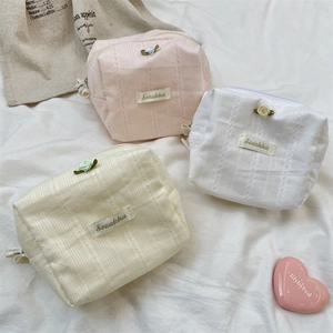 Detailed top view of rose lace vanity bags in pink, white, and yellow colors