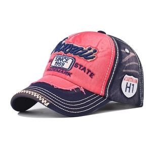 Detailed view of vintage washed baseball cap with WOTIII embroidery and distressed edges