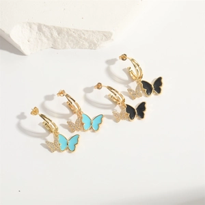 Golden butterfly drop earrings with black and light blue enamel and white rhinestones