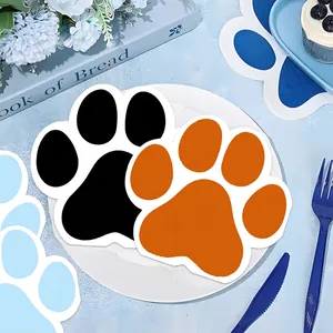 Colorful paw-shaped paper napkins and party decorations in a lifestyle table setting