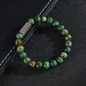 Detail of custom beaded bracelet with pink zebra stone and brushed steel charm