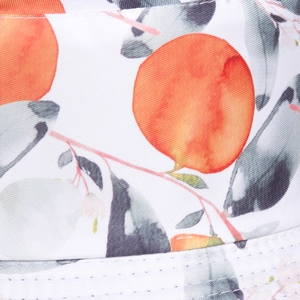 Close-up of orange fruit print and twill fabric texture on a cotton bucket hat