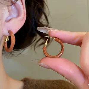 Brown enamel round hoop earrings with gold metal clasp for a minimalist retro look