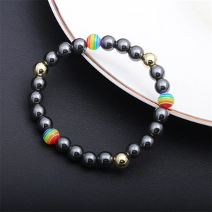Macro view of men's hematite beaded bracelet featuring rainbow and golden accent beads