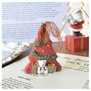 Detail of red resin Christmas tree ornament with polar bear figure and ribbon