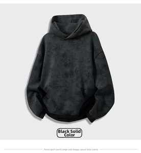 Detail view of oversized black tie-dye hoodie featuring washed-out vintage effect