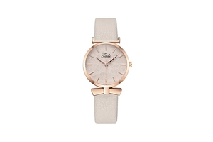 Macro detail of rose gold watch case with leaf pattern dial and cream leather strap