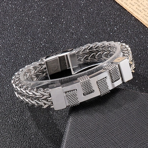 Close-up of rock hip-hop woven titanium steel bracelet with mesh-textured metal plaque