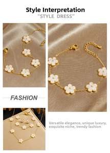 Detail of vintage gold plated chain with white pearlescent flower charms and earrings