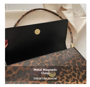 Detail of leopard print leather bag showing the premium magnetic hardware snap closure