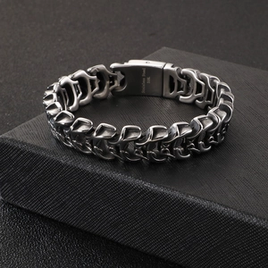 Punk style stainless steel 316L skull bracelet for men on a black textured gift box