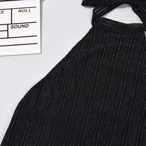 Close-up of black halter neck top with vertical ribbed knit and metallic silver sparkles