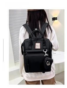 Detailed view of black waterproof diaper backpack with matching small round coin purse