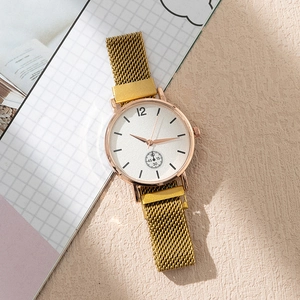 Angled view of rose gold quartz watch with mesh band and white dial on a textured surface