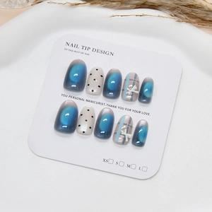 Handmade press-on nails set featuring sea salt blue cat eye effect and bow tie patterns