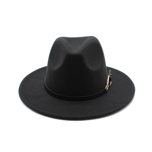 Detail of black wool fedora hat featuring a leather band and gold metal buckle accent