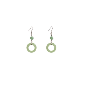 Detail view of green faux jade beaded earrings with metal hooks and circular pendants