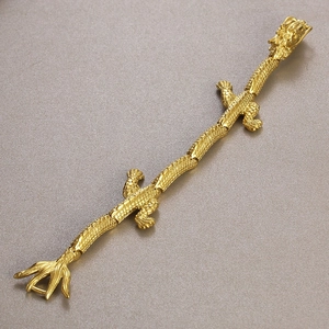 Detailed close-up of 18k gold-plated dragon bracelet showing intricate scale and claw work