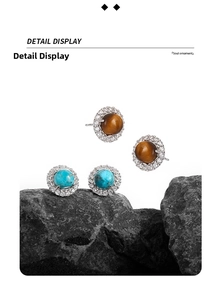 Detail display of circular S925 silver stud earrings with turquoise and tiger eye stones