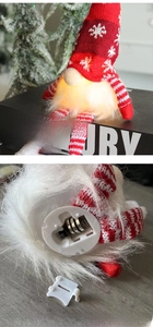 Close-up of LED Christmas gnome showing light switch and battery compartment detail