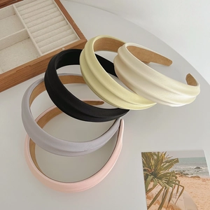Close-up of five colorful fresh headbands in pink, gray, black, yellow, and beige colors