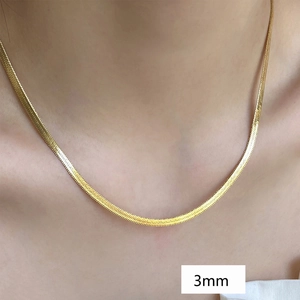 Close-up of 3mm wide gold snake bone chain necklace worn on neck highlighting texture