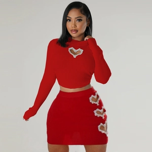 Close-up of heart-shaped rhinestone cut-outs on red ribbed knit crop top and skirt set