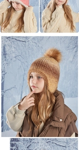 Detail of warm winter knit hat for kids with thick fleece lining and large pompom