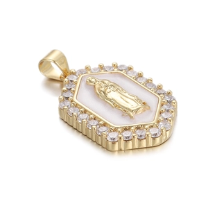 Macro shot of a gold-plated Virgin Mary hexagonal pendant with inlaid cubic zirconia