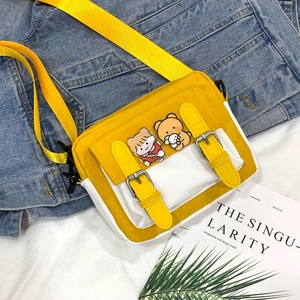 Detail of yellow and white nylon crossbody bag with cute cartoon patches and straps