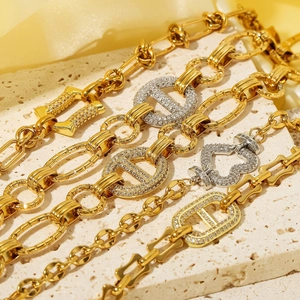 Luxury gold and silver stainless steel heart bracelet with cubic zirconia on stone background