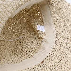 Detail of the inner paper straw weave with sweatband and adjustable drawstring ribbon