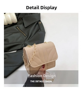 Detail view of beige PU leather mini crossbody bag with white fan-shaped stitching and chain