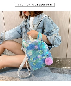Detail of colorful sequin unicorn backpack with silver stars and fluffy purple pompom