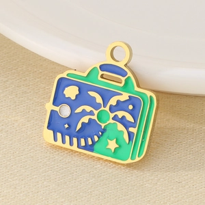 Golden suitcase pendant with enamel coconut tree and sunset design for jewelry making