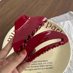 Large dark red acetate hair claw clip with vintage resin finish for elegant hair styling