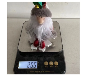 Christmas gnome plush ornament on a digital scale showing a precise weight of 26.6 grams