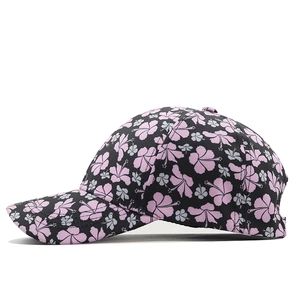 Side view detail of black baseball cap with tropical pink and grey hibiscus floral print