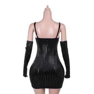 Detail view of the sequined black velvet dress with matching long gloves from the back