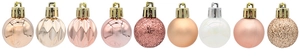 Close-up of assorted pink, gold, and white Christmas balls with matte and glitter textures