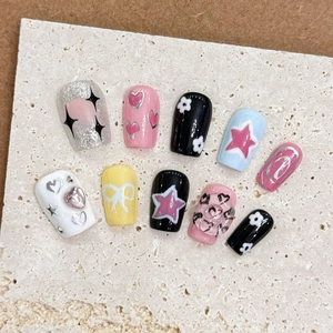 Handmade press-on nails with 3D stars, hearts and bow designs in long trapezoid shape