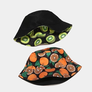 Reversible bucket hat featuring creative fruit prints and solid black cotton twill fabric