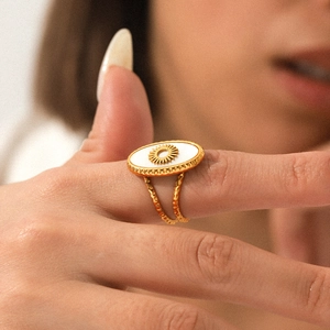 Golden stainless steel sun totem ring with white shell inlay and twisted band