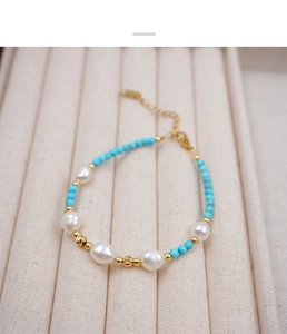 Detail of beaded bracelet with freshwater pearls, turquoise beads and gold clasp