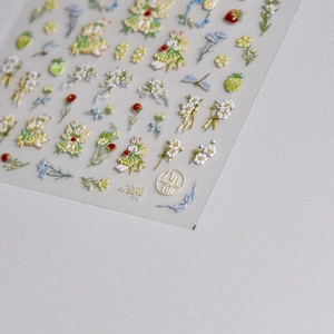 Close-up of 3D embossed nail stickers featuring cute rabbits and floral garden patterns